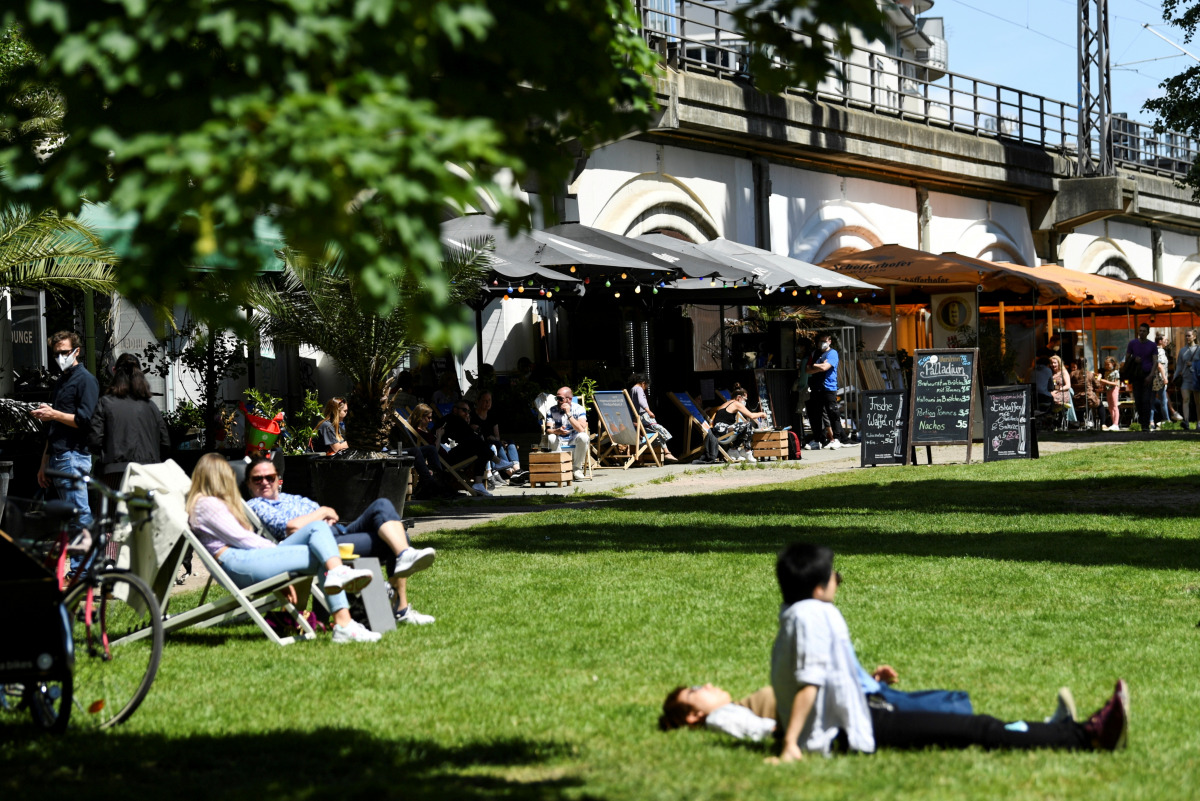 FILE PHOTO: People enjoy the warm weather as they sit outside at restaurants near James-Simon-Park, amid the coronavirus disease (COVID-19) pandemic, in Berlin, Germany May 30, 2021. REUTERS/Annegret Hilse/File Photo
