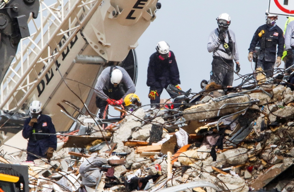 Emergency workers conduct search and rescue efforts at the site of a partially collapsed residential building in Surfside, near Miami Beach, Florida, U.S. June 30, 2021. REUTERS/Joe Skipper