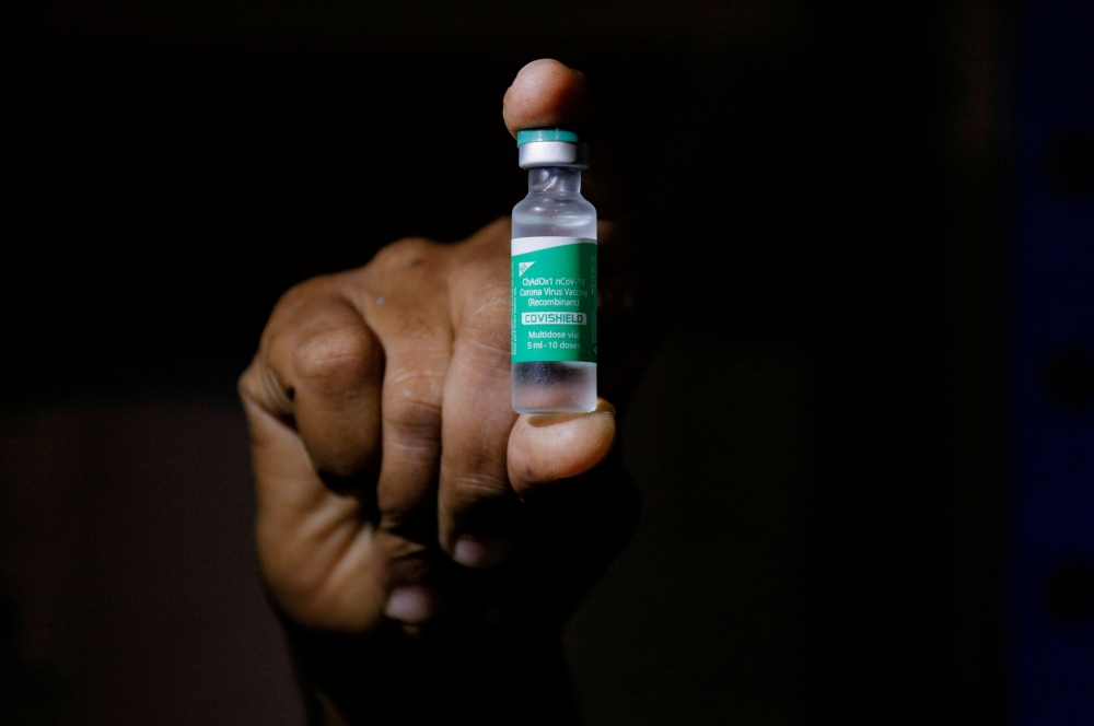 A man displays a vial AstraZeneca's COVISHIELD vaccine as the country receives its first batch of coronavirus disease (COVID-19) vaccines under COVAX scheme, in Accra, Ghana February 24, 2021. REUTERS/Francis Kokoroko/File Photo/File Photo