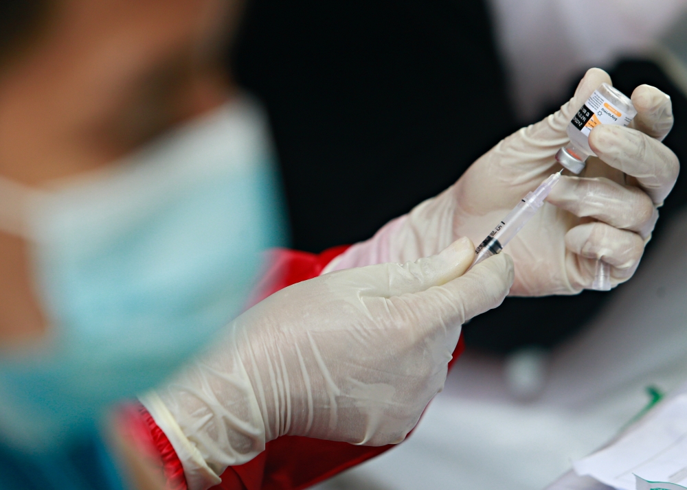 A health care worker prepares a dose of China's Sinovac Biotech vaccine for the coronavirus disease (COVID-19), during the mass vaccination program at the Tangerang City Government Center, in Tangerang on the outskirts of Jakarta, Indonesia, June 30, 2021