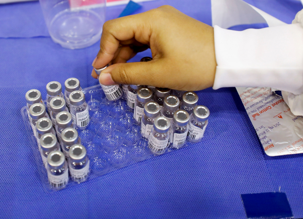A medical worker holds a Sinovac coronavirus disease (COVID-19) vaccine container as the Thai resort island of Phuket rushes to vaccinate its population amid the COVID-19 outbreak ahead of a July 1 end of strict quarantine for overseas visitors to bring b
