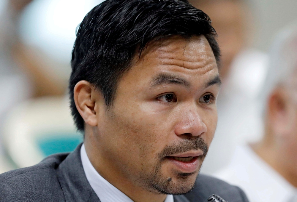 FILE PHOTO: Philippine Senator and boxer Manny Pacquiao speaks during the Congressional confirmation hearing of Environment Secretary Regina Lopez at the Senate in Manila, Philippines May 2, 2017. REUTERS/Erik De Castro