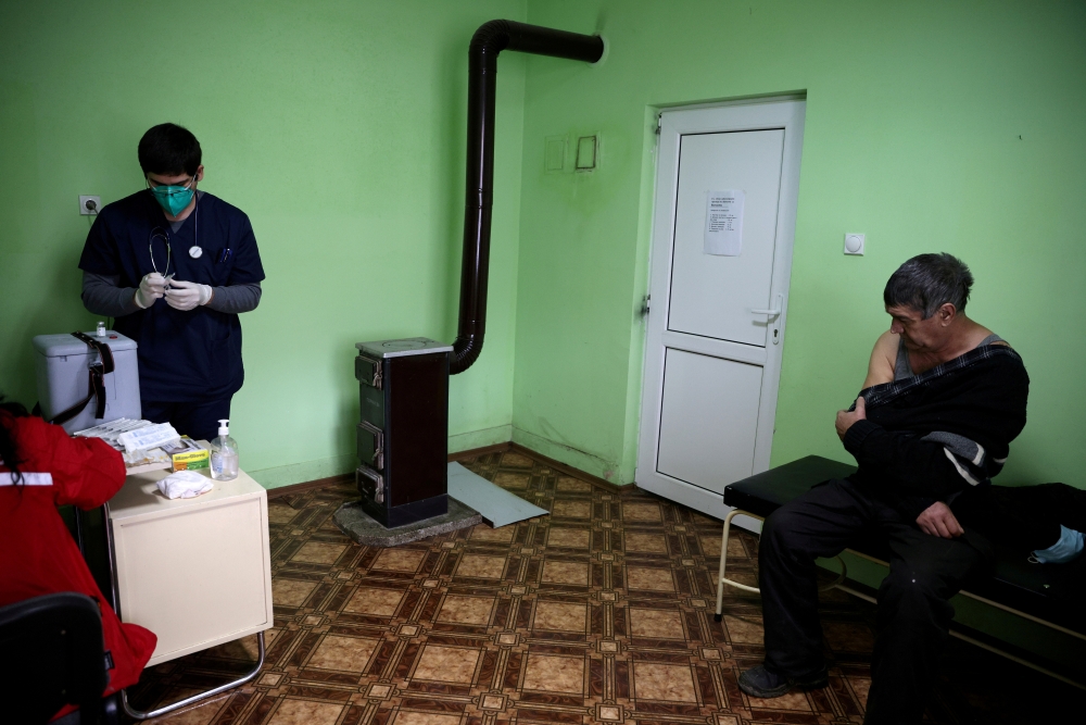 A man waits to receive a dose of AstraZeneca's coronavirus disease (COVID-19) vaccine administered by medical personnel from a mobile unit in the village of Ognen, Bulgaria, February 25, 2021. REUTERS/Stoyan Nenov/File Photo/File Photo/File Photo