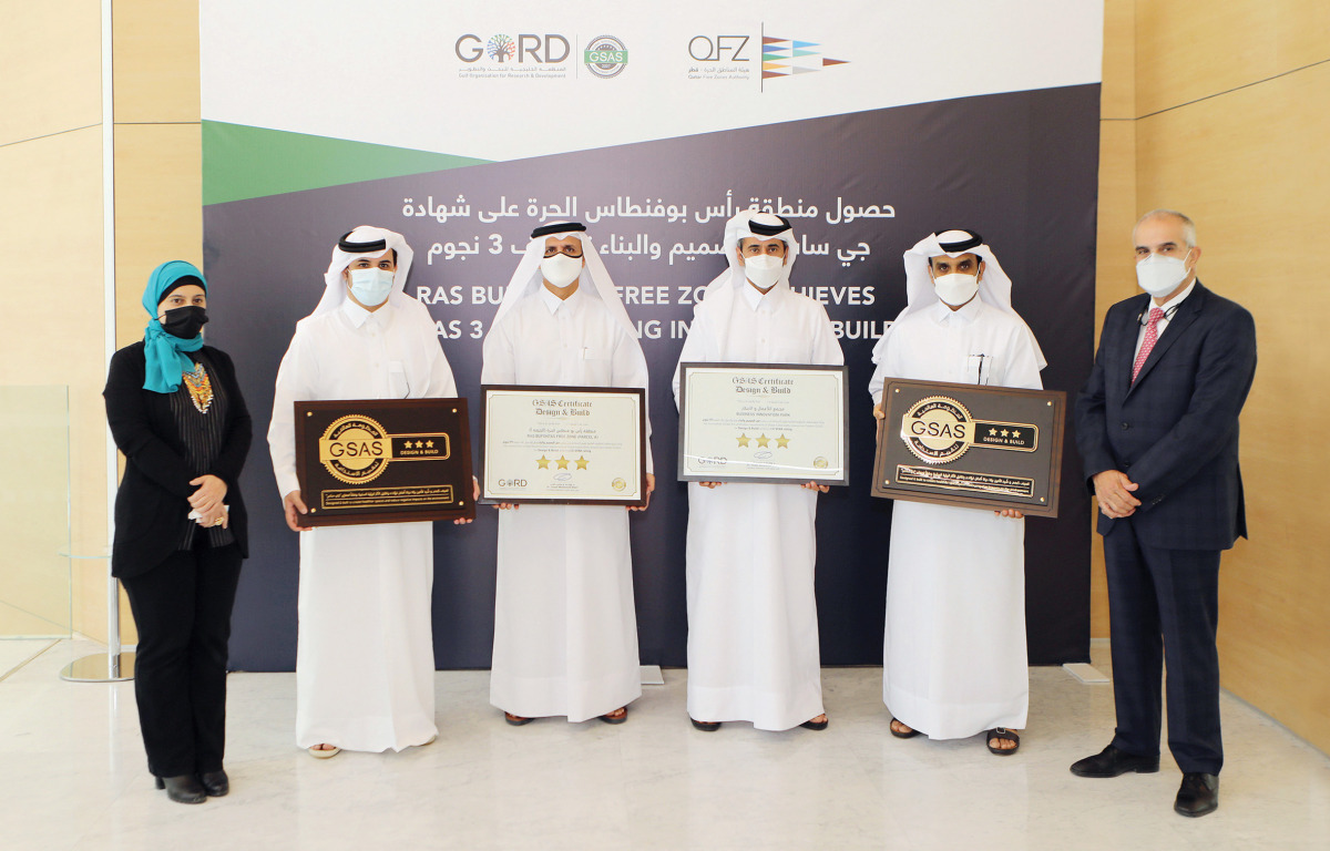 Officials posing with the certificates during the award ceremony.
