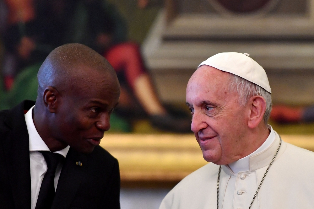 FILE PHOTO: Pope Francis talks with Haiti's President Jovenel Moise during a Private Audience at the Vatican January 26, 2018. REUTERS/Alberto Pizzoli/Pool
