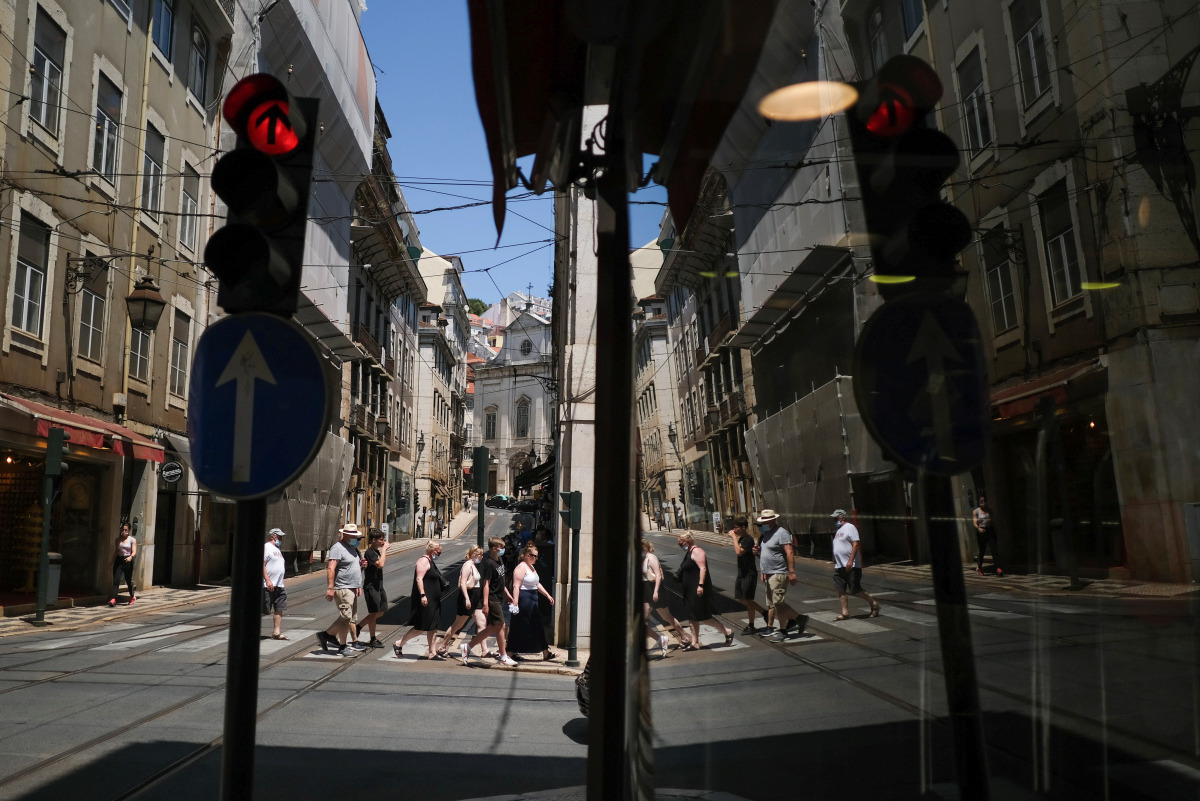 People wearing protective masks walk in Lisbon downtown amid the coronavirus disease (COVID-19) pandemic, in Lisbon, Portugal, July 8, 2021. REUTERS/Pedro Nunes
