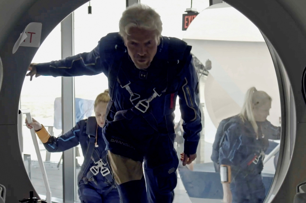 Richard Branson and Virgin Galactic crew members enter the company's passenger rocket plane, the VSS Unity, in a still image from undated handout video taken at Spaceport America near Truth or Consequences, New Mexico, U.S. Virgin Galactic/Handout via REU