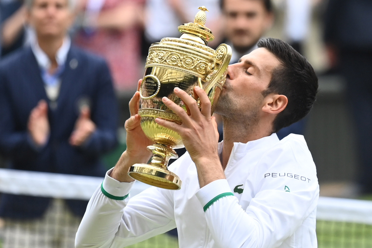 Tennis - Wimbledon - All England Lawn Tennis and Croquet Club, London, Britain - July 11, 2021 Serbia's Novak Djokovic celebrates with the trophy after winning his final match against Italy's Matteo Berrettini REUTERS/Toby Melville
