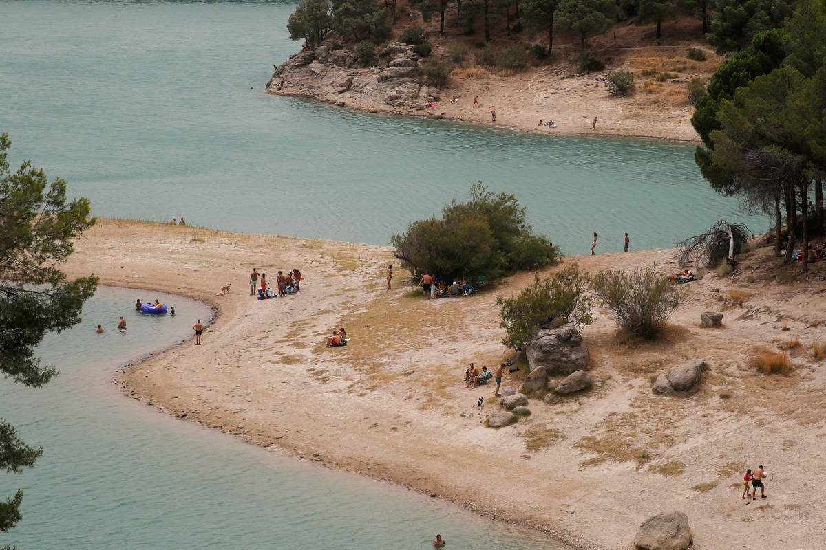 People cool off at Conde del Guadalhorce reservoir as the summer's first heatwave hits the country, in El Chorro, near Ardales, Spain July 11, 2021. REUTERS/Jon Nazca
