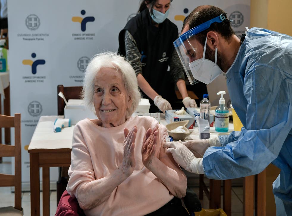 FILE PHOTO: An elderly woman claps her hands after receiving a vaccine against the coronavirus at a nursing home in Athens, Greece, January 25, 2021/REUTERS