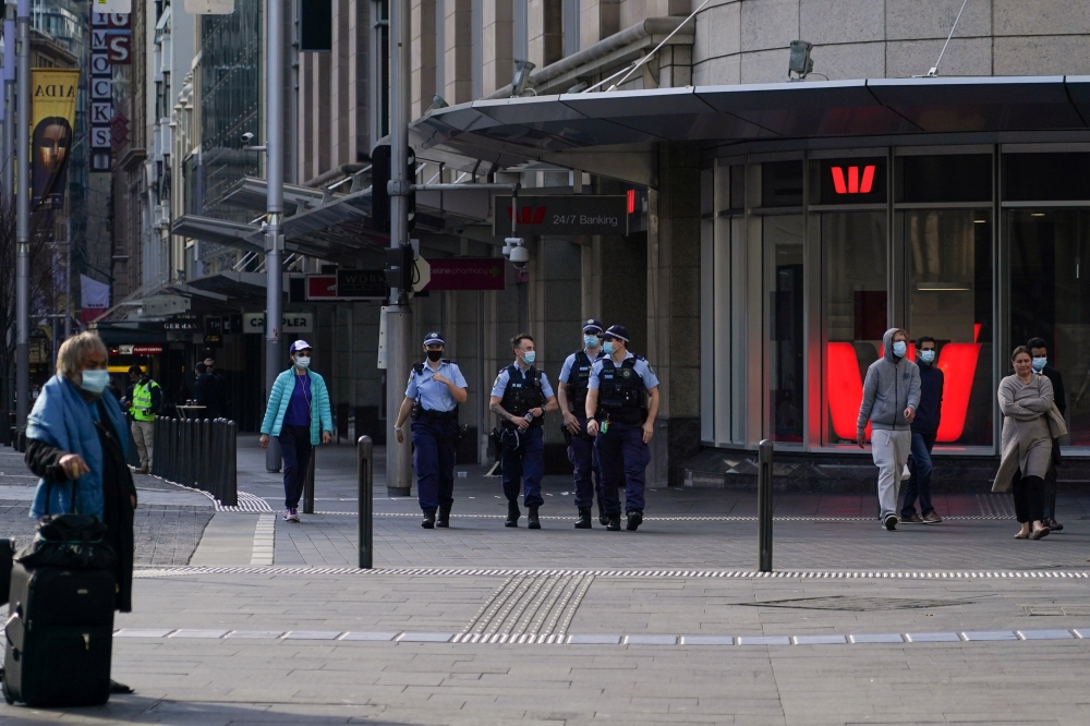 Police patrol in the city centre during a lockdown to curb the spread of a coronavirus disease (COVID-19) outbreak in Sydney, Australia, July 12, 2021. REUTERS/Loren Elliott