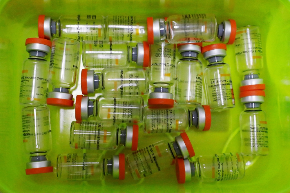 Bottles of the Sinovac vaccine are seen at a hospital, as Indonesia drives mass vaccination for the coronavirus disease (COVID-19), in Jakarta, Indonesia, January 21, 2021. REUTERS/Willy Kurniawan/File Photo