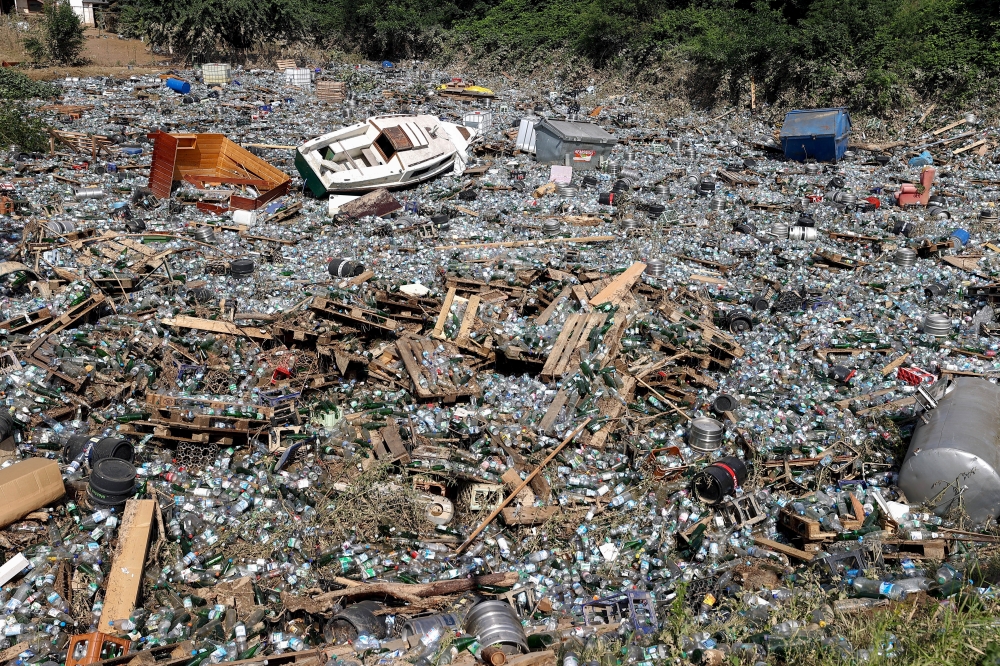 Trash, including bottles and barrels, is pictured following heavy rainfalls in Bad Neuenahr-Ahrweiler, Germany, July 18, 2021. REUTERS/Wolfgang Rattay