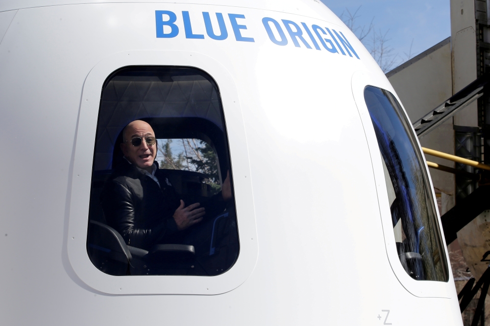 Amazon and Blue Origin founder Jeff Bezos addresses the media about the New Shepard rocket booster and Crew Capsule mockup at the 33rd Space Symposium in Colorado Springs, Colorado, United States April 5, 2017. REUTERS/Isaiah J. Downing/File Photo