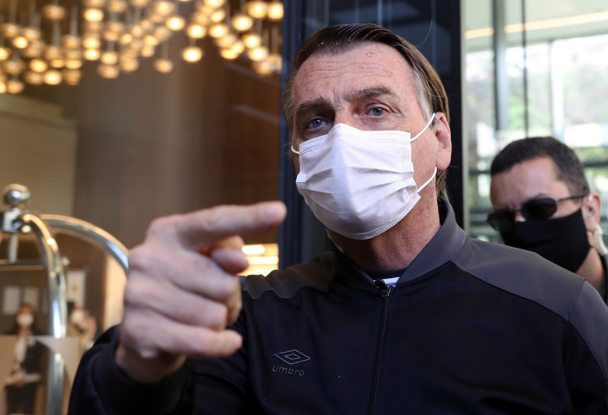 Brazil's President Jair Bolsonaro gestures, wearing a face mask, as he leaves Vila Nova Star Hospital, where he was treated due to obstructed intestine, in Sao Paulo, Brazil July 18, 2021. REUTERS/Amanda Perobelli
