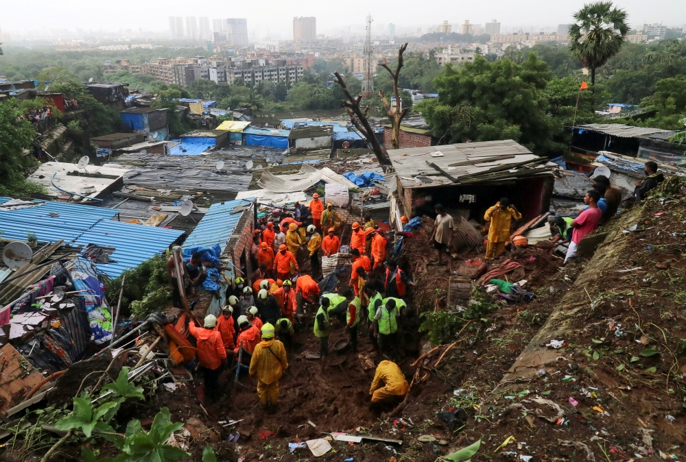 Rescue workers search for survivors after a residential house collapsed due to landslide caused by heavy rainfall in Mumbai, India, July 18, 2021. REUTERS/Niharika Kulkarni/File Photo