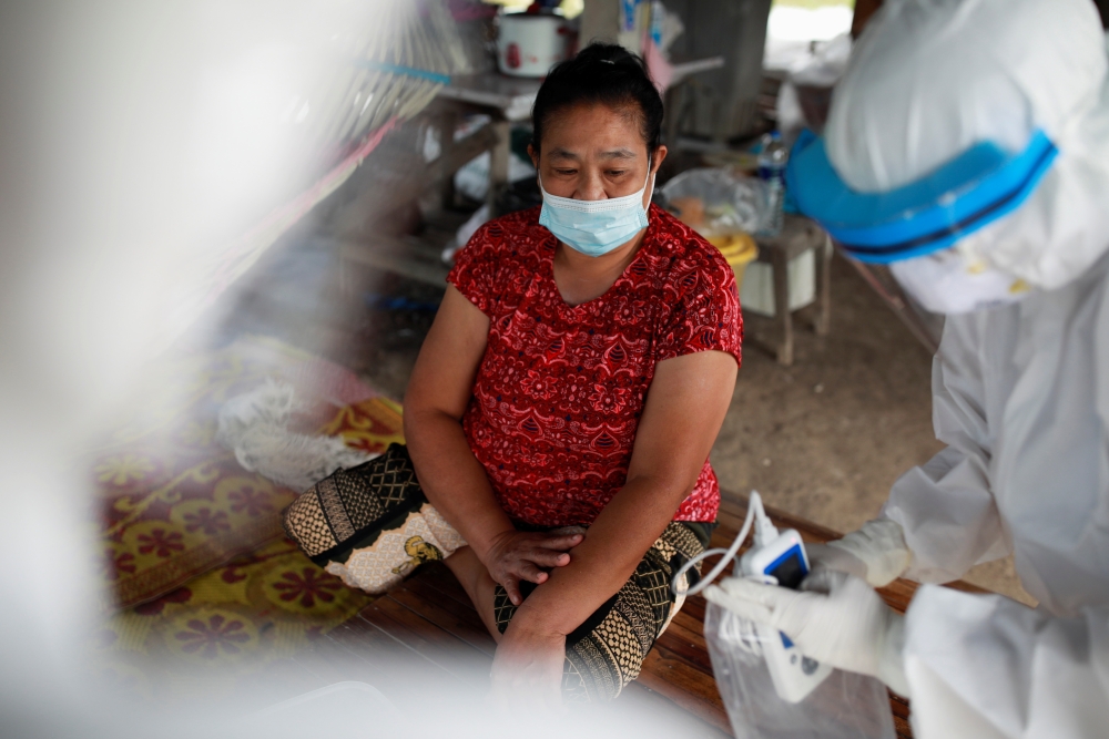 Public health officers prepare to administer a coronavirus disease (COVID-19) swab test as they bring testing to residents living in remote communities, amid the rise of coronavirus disease infections, in Samut Prakan, near Bangkok, Thailand, July 19, 202