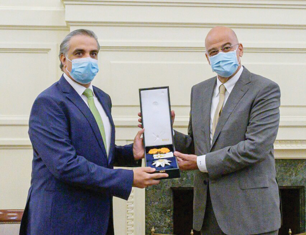 Minister of Foreign Affairs of Greece H E Nikos Dendias bestowing the Order of the Phoenix on Ambassador of the State of Qatar to Greece, H E Abdulaziz Ali Al Naama.