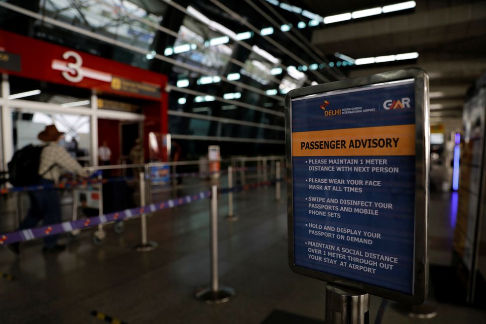 An advisory encouraging people to maintain social distancing and weara a protective face mask is seen, after the government allowed domestic flight services to resume from coming Monday, during an extended nationwide lockdown to slow the spread of the cor