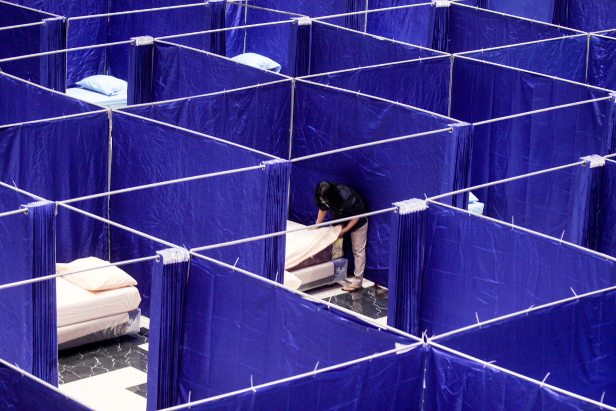 A worker prepares rooms to isolate coronavirus disease (COVID-19) patients at a shopping mall, as cases surge in Sidoarjo, East Java province, Indonesia July 19, 2021, in this photo taken by Antara Foto/Umarul Faruq via REUTERS 