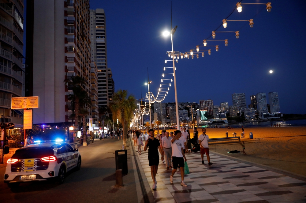 Tourists enjoy Benidorm's Levante beach at night, Spain, July 22, 2021. REUTERS/Eva Manez