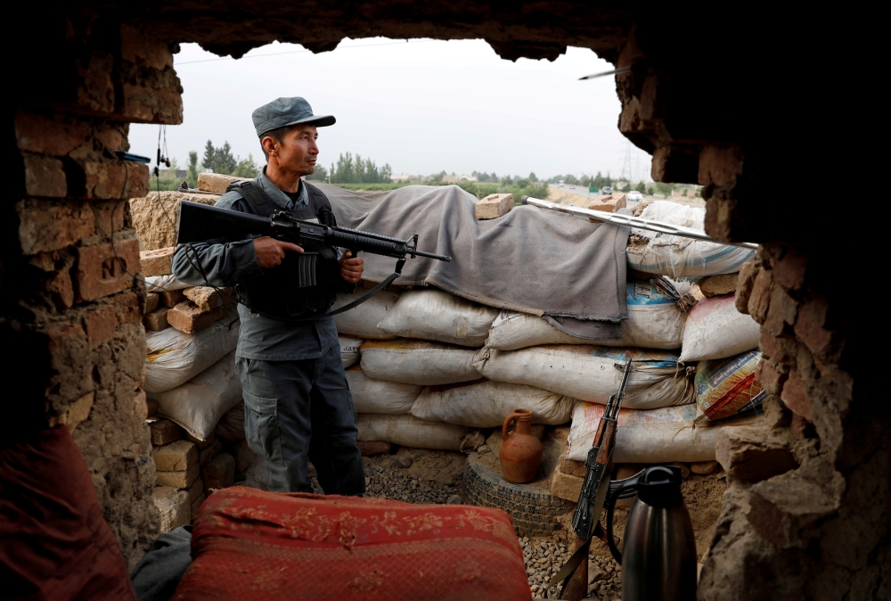 An Afghan policeman keeps watch at the check post on the outskirts of Kabul, Afghanistan July 13, 2021. (Reuters/Mohammad Ismail//File Photo)