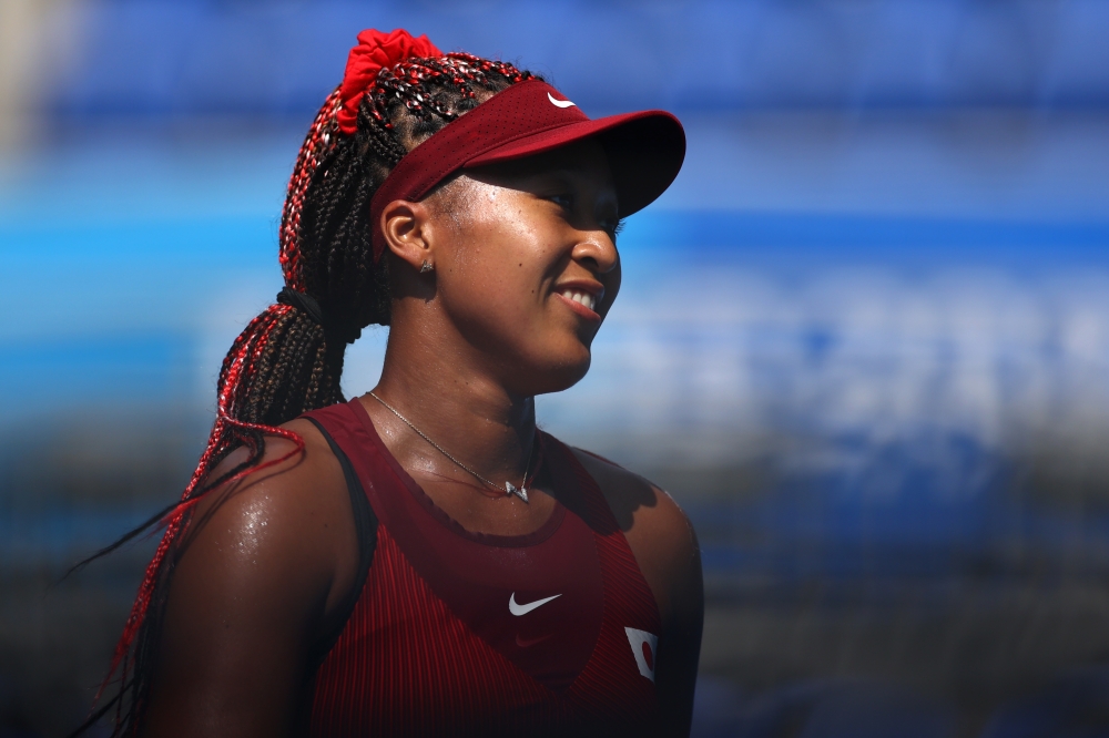 July 25, 2021. Naomi Osaka of Japan celebrates after winning her first round match against Zheng Saisai of China REUTERS/Edgar Su