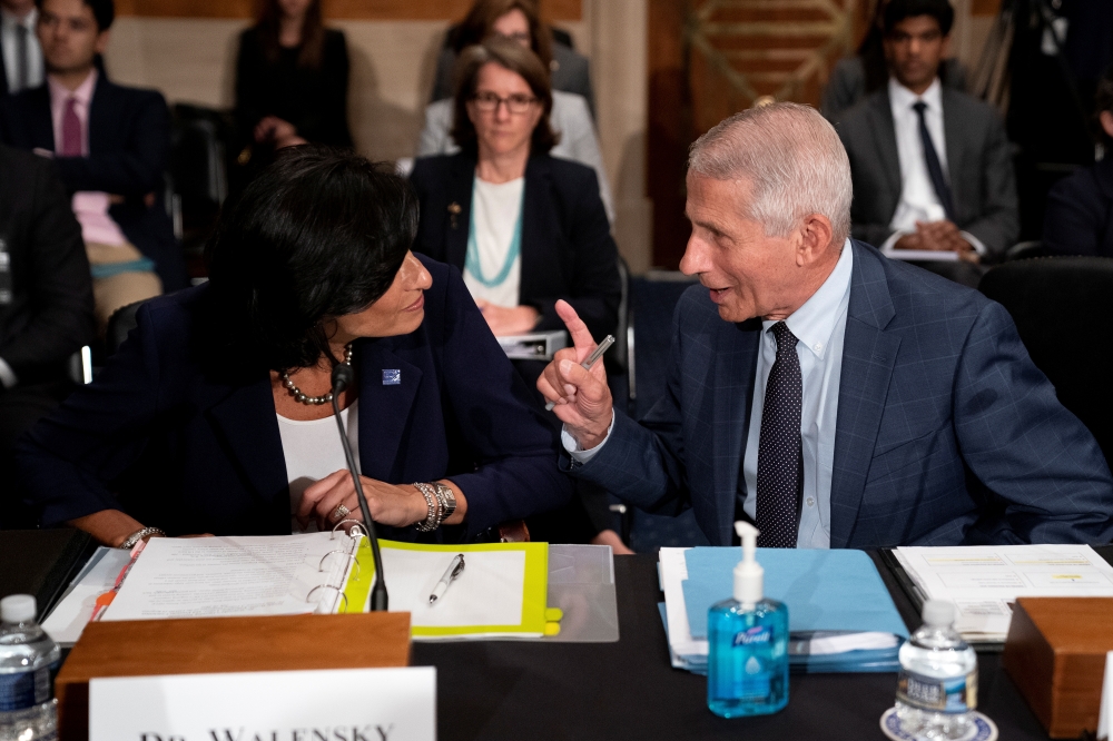 Dr. Anthony Fauci, director of the National Institute of Allergy and Infectious Diseases, speaks to Rochelle Walensky, Director of the Centers for Disease Control and Prevention, prior to a Senate Health, Education, Labor, and Pensions Committee hearing o