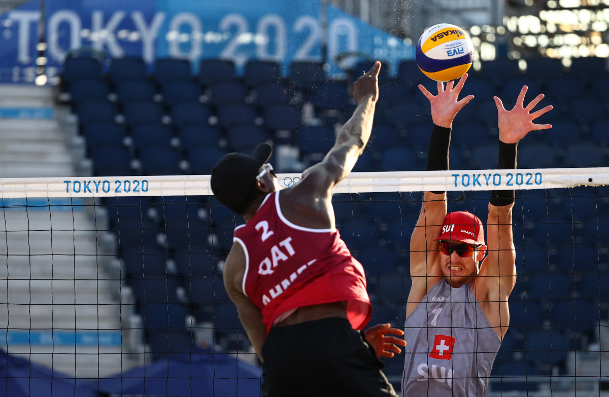 Qatar's Ahmed Tijan shoots to score against Switzerland during the Pool C Beach Volleyball match played at the Shiokaze Park in Tokyo, yesterday. Qatar's Cherif and Ahmed defeated the Swiss duo, Heidrich and Gerson 21-17, 21-16.