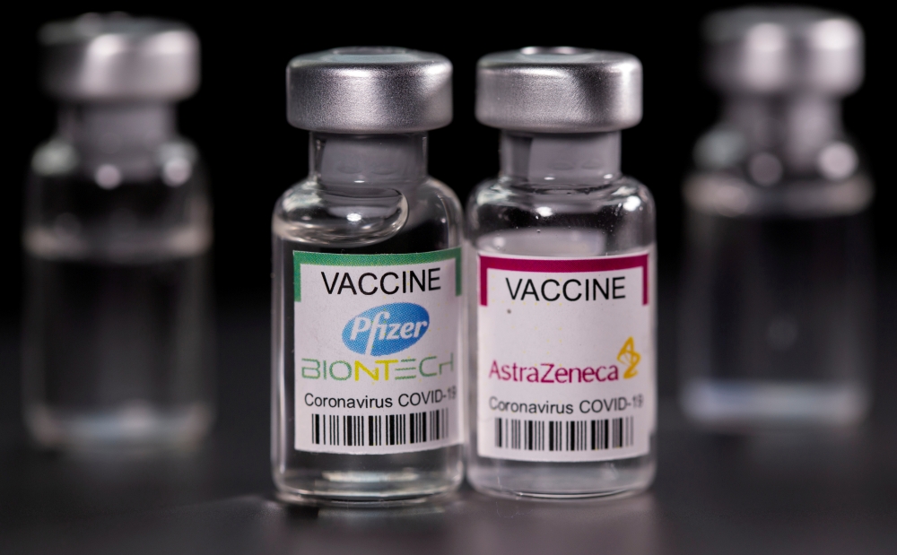File photo: Vials with Pfizer-BioNTech and AstraZeneca coronavirus disease (COVID-19) vaccine labels are seen in this illustration picture taken March 19, 2021. Reuters/Dado Ruvic/Illustration/File Photo