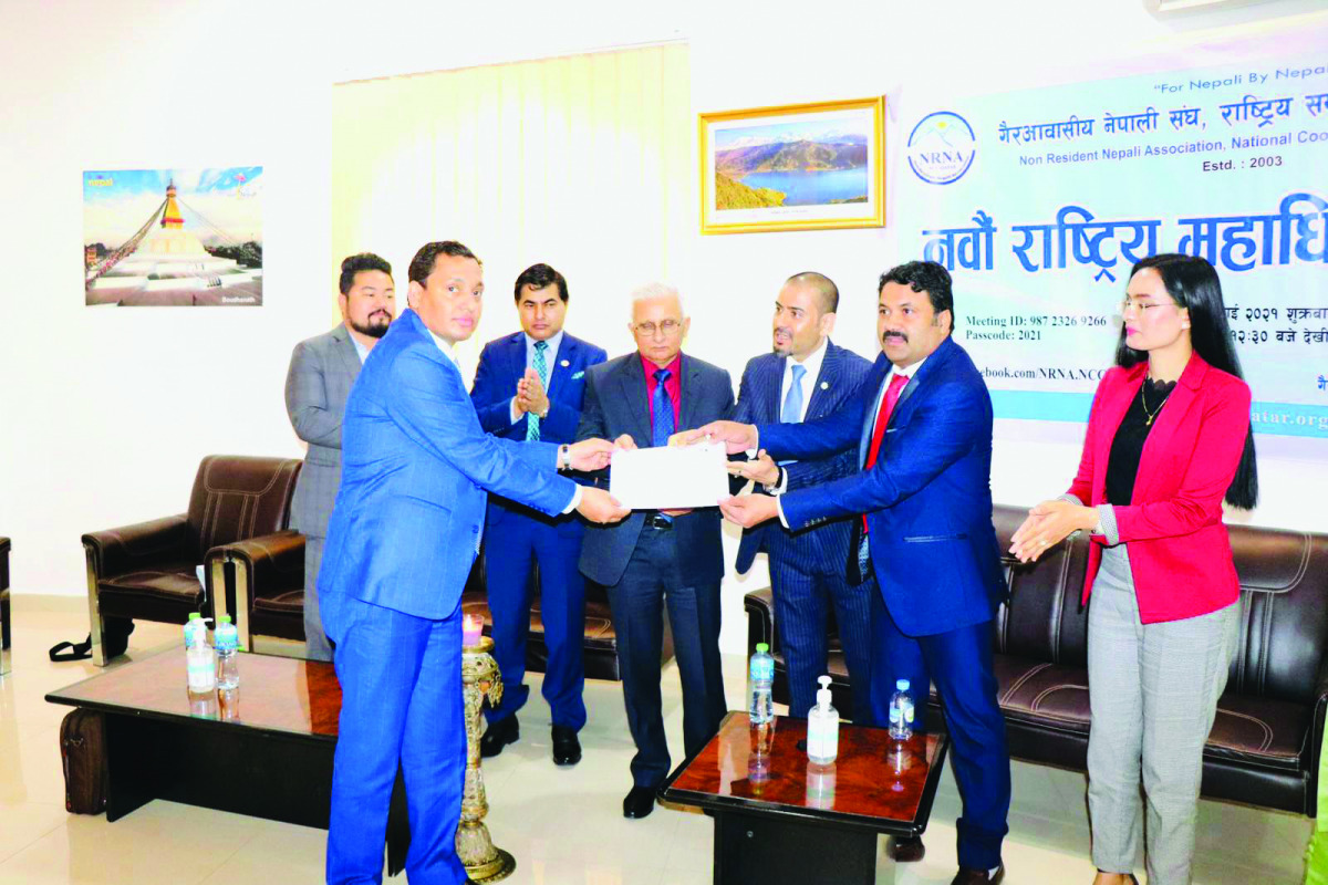 Ambassador of Nepal to Qatar, H E Dr. Narad Nath Bharadwaj, with newly elected members of NRNA’s National Coordination Council Qatar, during an event.