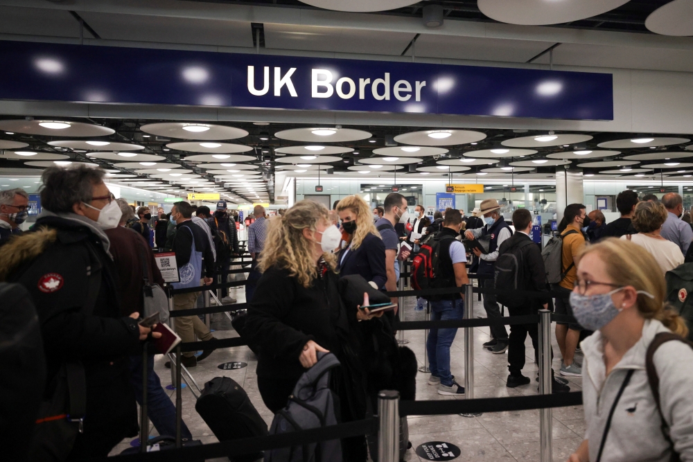 Arriving passengers queue at UK Border Control at the Terminal 5 at Heathrow Airport in London, Britain June 29, 2021. REUTERS/Hannah Mckay/File Photo