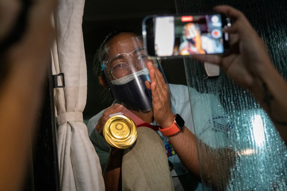 Weightlifter Hidilyn Diaz, the Philippines' first Olympic Gold medalist, arrives home from Tokyo, at the Ninoy Aquino International Airport, Pasay City, Philippines, July 28, 2021. REUTERS/Eloisa Lopez