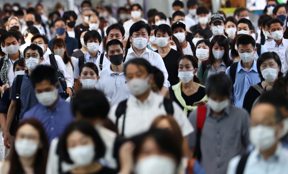 Commuters wearing protective masks amid the coronavirus disease (COVID-19) outbreak make their way at Shinagawa station in Tokyo, Japan, July 28, 2021. REUTERS/Kim Kyung-Hoon