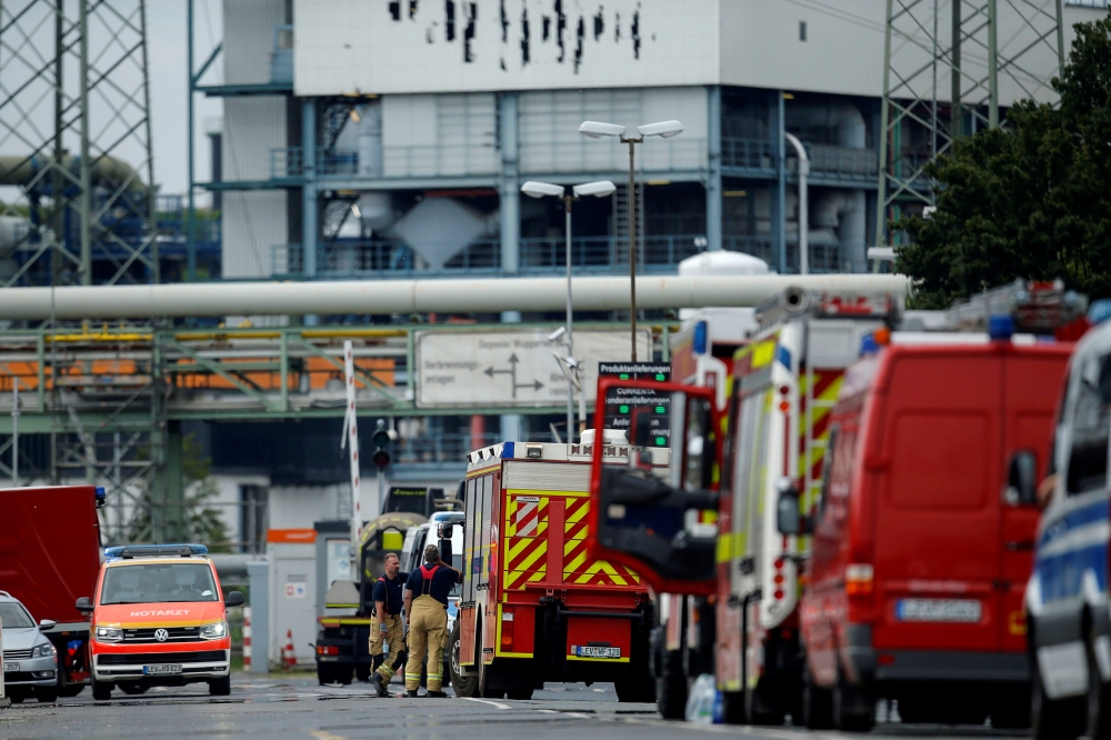 Firefighters stand outside Chempark following an explosion in Leverkusen, Germany, July 27, 2021. REUTERS/Leon Kuegeler/File Photo