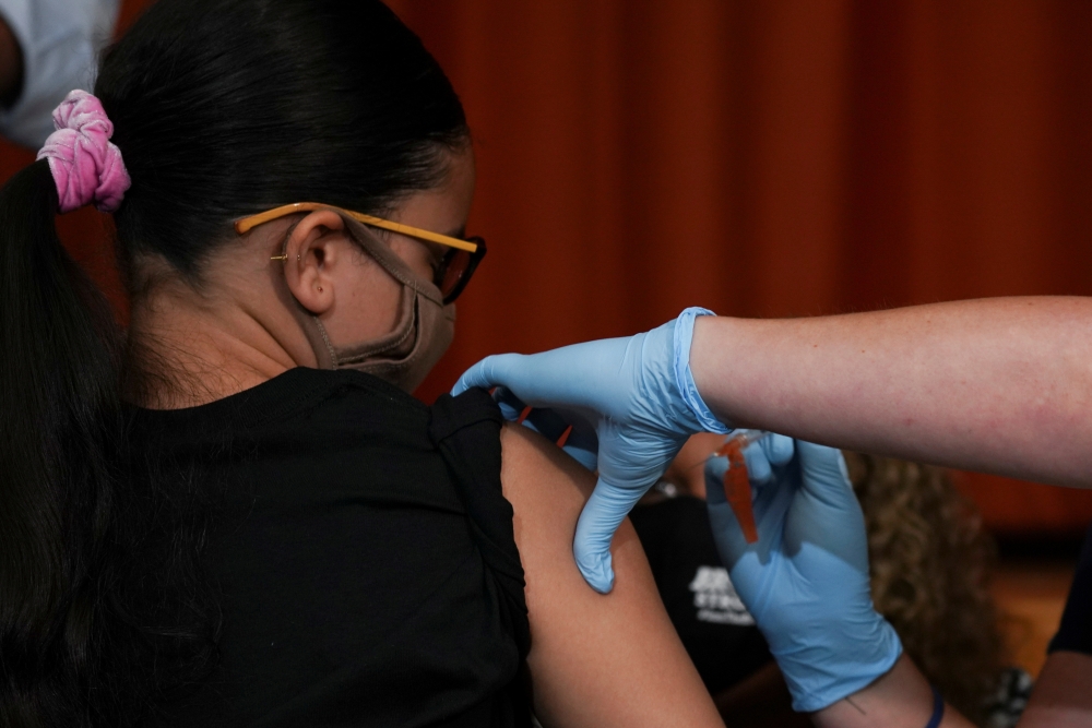 Ariel Quero (16) receives a dose of the Pfizer-BioNTech COVID-9 vaccine at a vaccination clinic at Lehman High School in the Bronx borough of New York City, US, on July 27, 2021. Reuters/File Photo