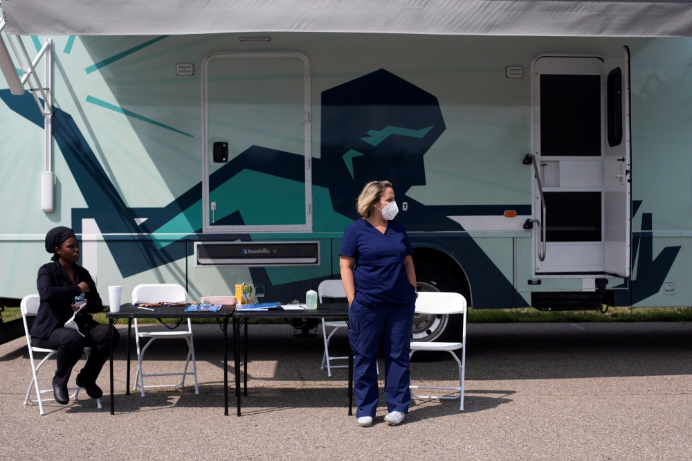 Nurses wait for people to come by to receive their coronavirus disease (COVID-19) vaccine at a mobile pop-up vaccination clinic hosted by the Detroit Health Department with the Detroit Public Schools Community District at East English Village Preparatory 