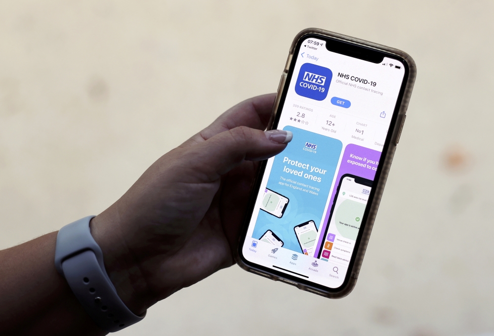 The coronavirus disease (COVID-19) contact tracing smartphone app of Britain's National Health Service (NHS) is displayed on an iPhone in this illustration photograph taken in Keele, Britain, September 24, 2020. REUTERS/Carl Recine/Illustration/File Photo