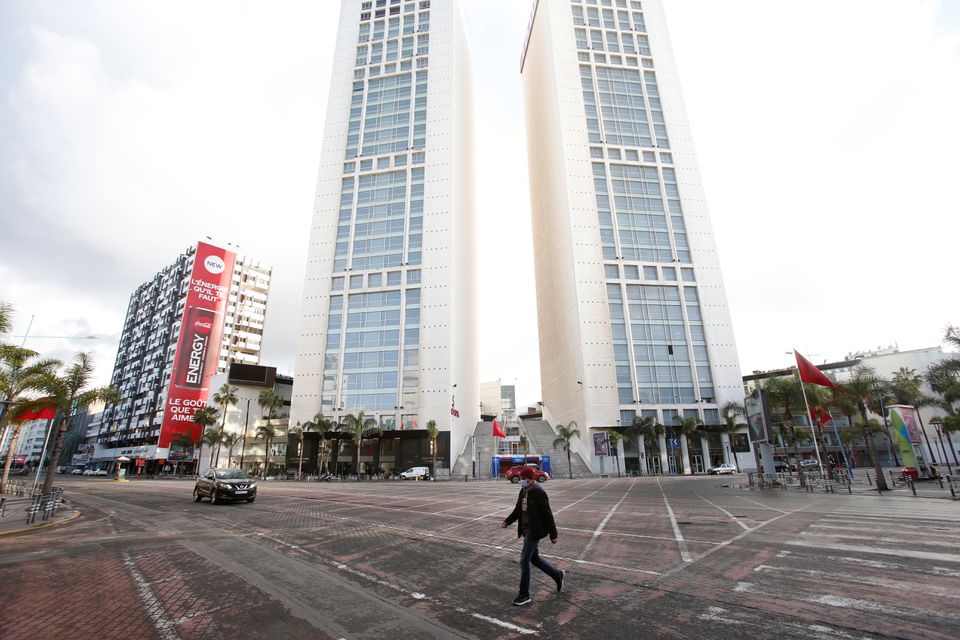 A man wearing a protective face mask walks on an empty street, following the coronavirus disease (COVID-19) outbreak, in Casablanca, Morocco March 24, 2020. REUTERS/Youssef Boudlal

