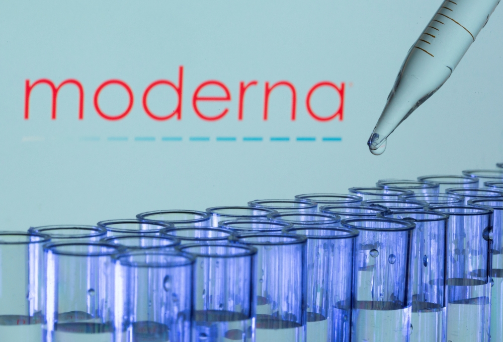 Test tubes are seen in front of a displayed Moderna logo in this illustration taken, May 21, 2021. REUTERS/Dado Ruvic/Illustration//File Photo
