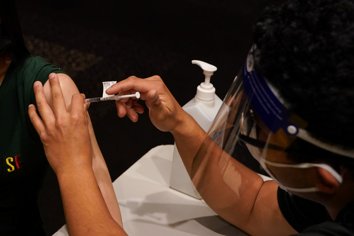 A patient receives the AstraZeneca vaccine administered by a nurse immuniser at a coronavirus disease (COVID-19) vaccination clinic at the Bankstown Sports Club as the city experiences an extended lockdown, in Sydney, Australia, August 3, 2021. REUTERS/Lo