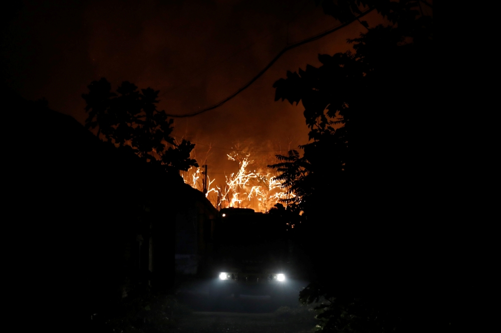 A view of smoke rising from a wildfire is seen from Kifisia, northern suburb of Athens, Greece, August 3, 2021. Fotis Chormovitis via Reuters 