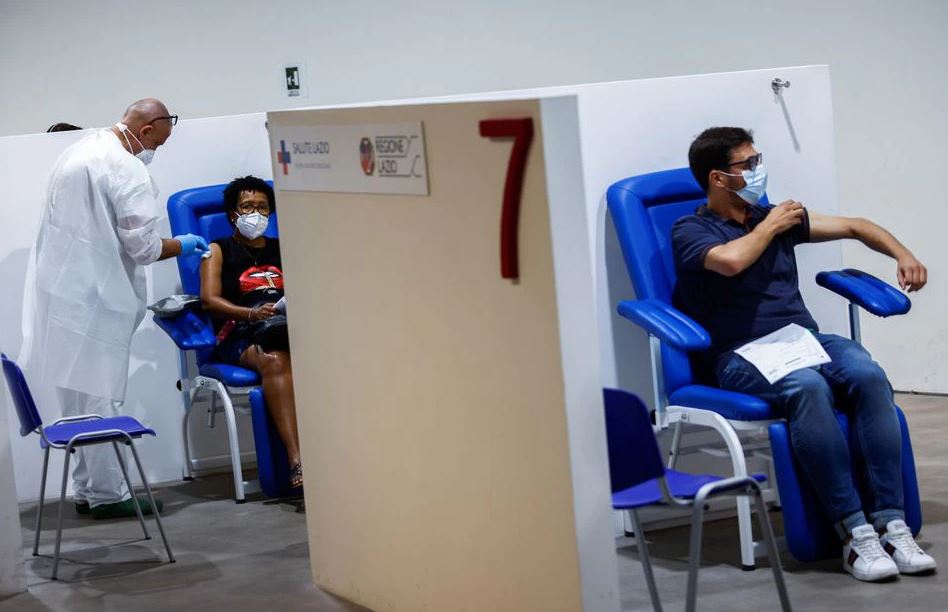 People receive a dose of the Moderna vaccine against the coronavirus disease (COVID-19), a day before the wider Green Pass restrictions, where Italians will need proof of immunity to access an array of services and leisure activities, come into force, at 