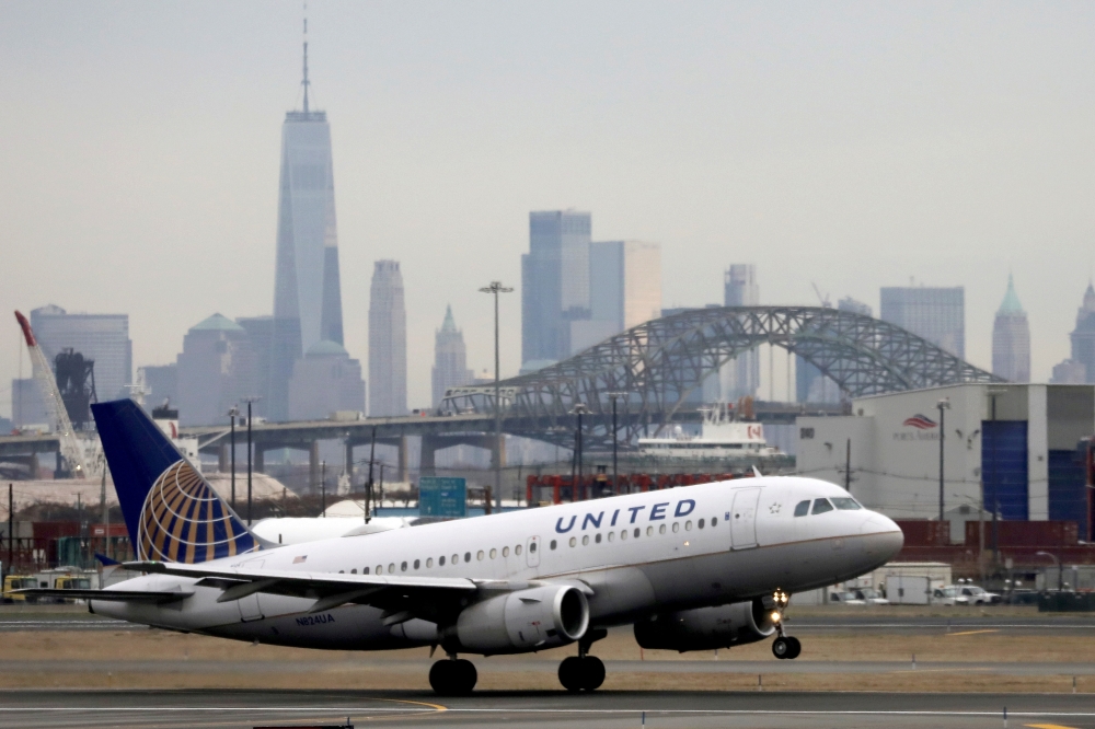 A United Airlines passenger jet takes off with New York City as a backdrop, at Newark Liberty International Airport, New Jersey, U.S. December 6, 2019. REUTERS/Chris Helgren/File Photo