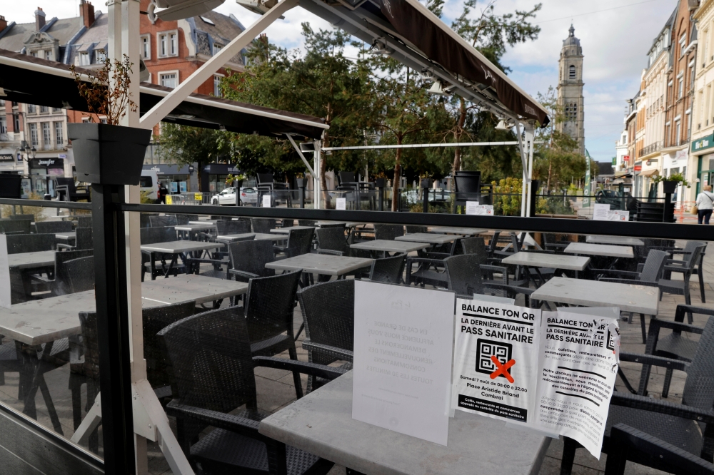 Empty chairs and tables are seen in a closed restaurant bar as owners protest against France's coronavirus disease (COVID-19) safety restrictions in Cambrai, France, August 7, 2021. Reuters/Pascal Rossignol