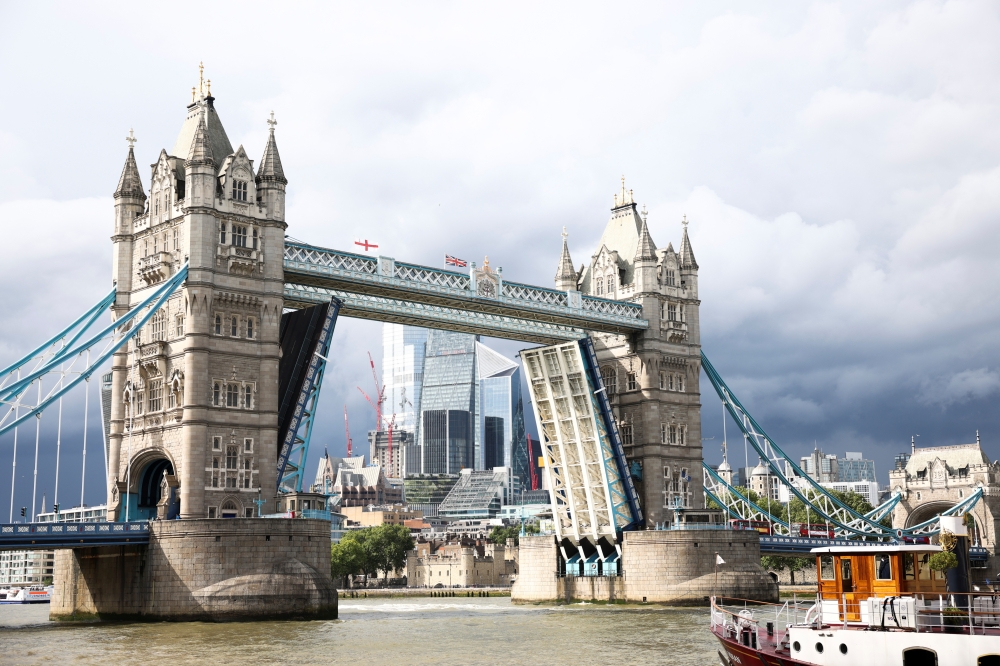 Tower Bridge is seen stuck in the open position, due to a technical fault, in London, Britain, August 9, 2021. Reuters/Henry Nicholls
