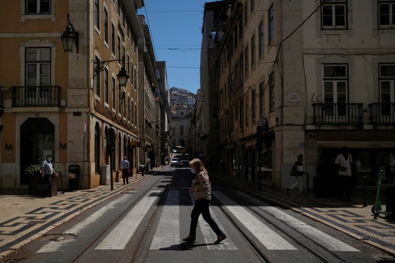 FILE PHOTO: A person wearing a protective mask walks in Lisbon downtown amid the coronavirus disease (COVID-19) pandemic, in Lisbon, Portugal, June 24, 2021. REUTERS/Pedro Nunes/File Photo