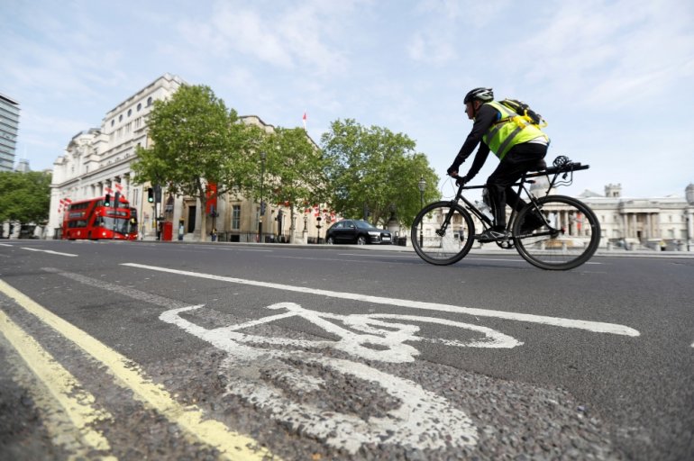 A man cycles by a cycle lane in Trafalgar Square, following the outbreak of the coronavirus disease (COVID-19), London, Britain, May 16, 2020. REUTERS/Peter Nicholls/File Photo