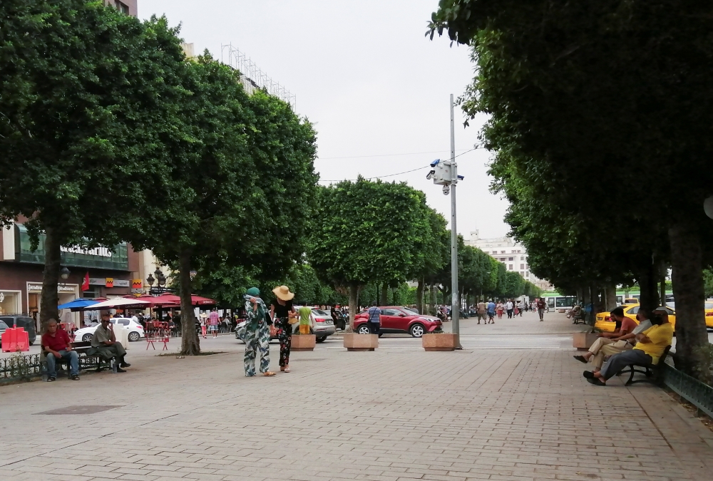 People walk along a street during a heat wave, in Tunis, Tunisia August 11, 2021. REUTERS/Jihed Abidellaoui