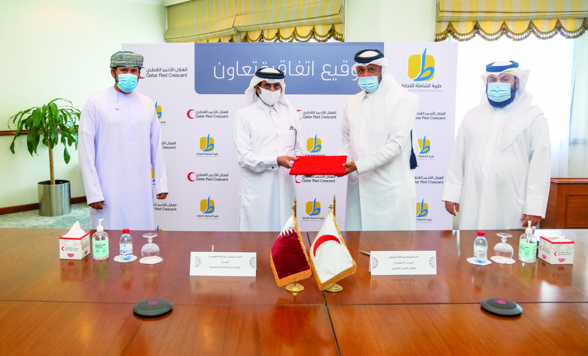 QRCS CEO Eng. Ibrahim Abdullah Al Malki and Director of Tayibah Mohamed Abdullah Ali Al Suwaidi exchanging document after signing the agreement.